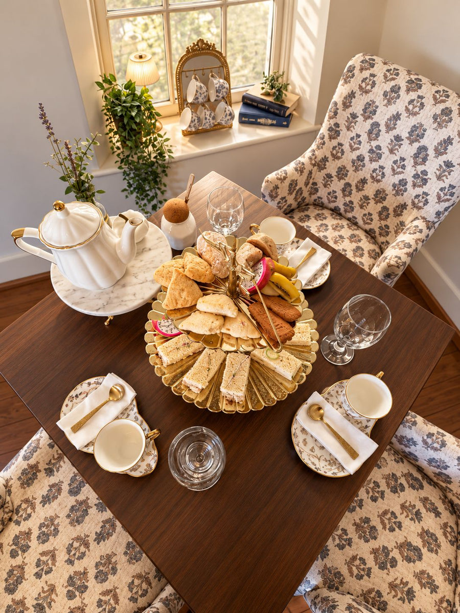 Afternoon tea for four at a window table inside Blue Thistle Tea Haus